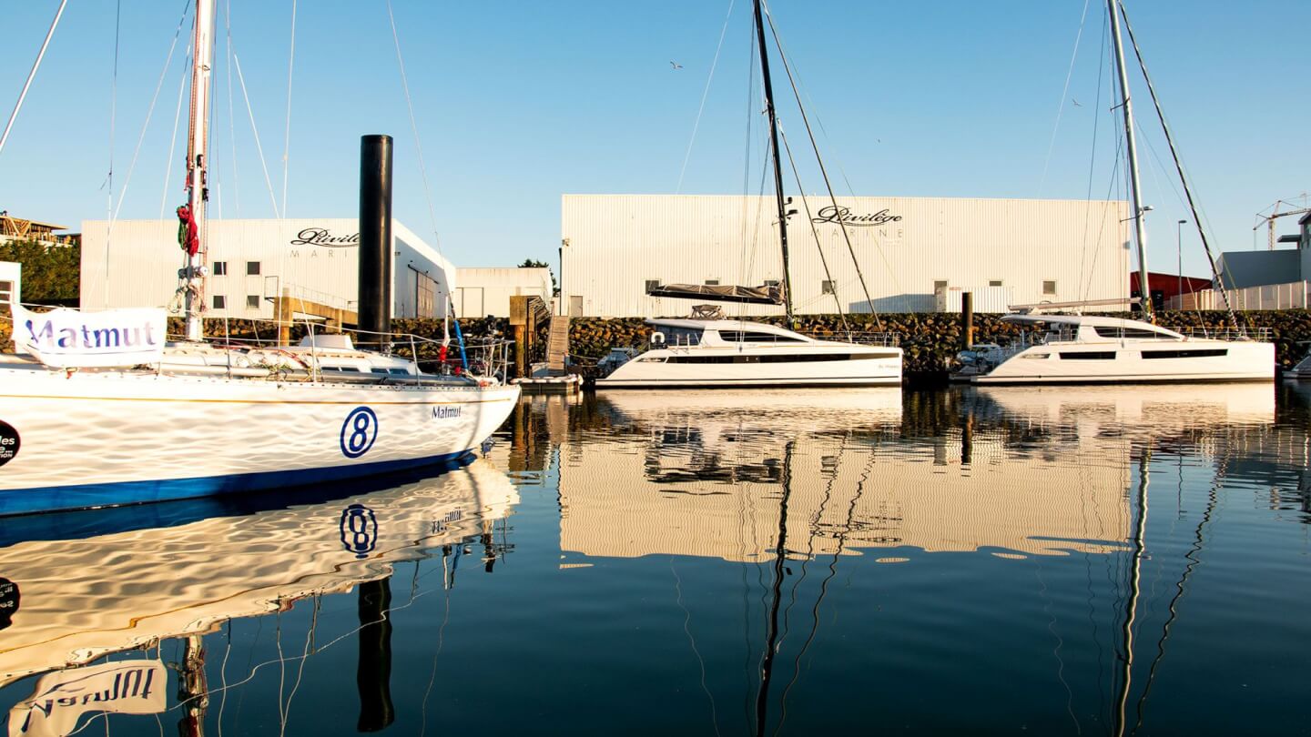 New luxury sailing yachts at dock outside of factory